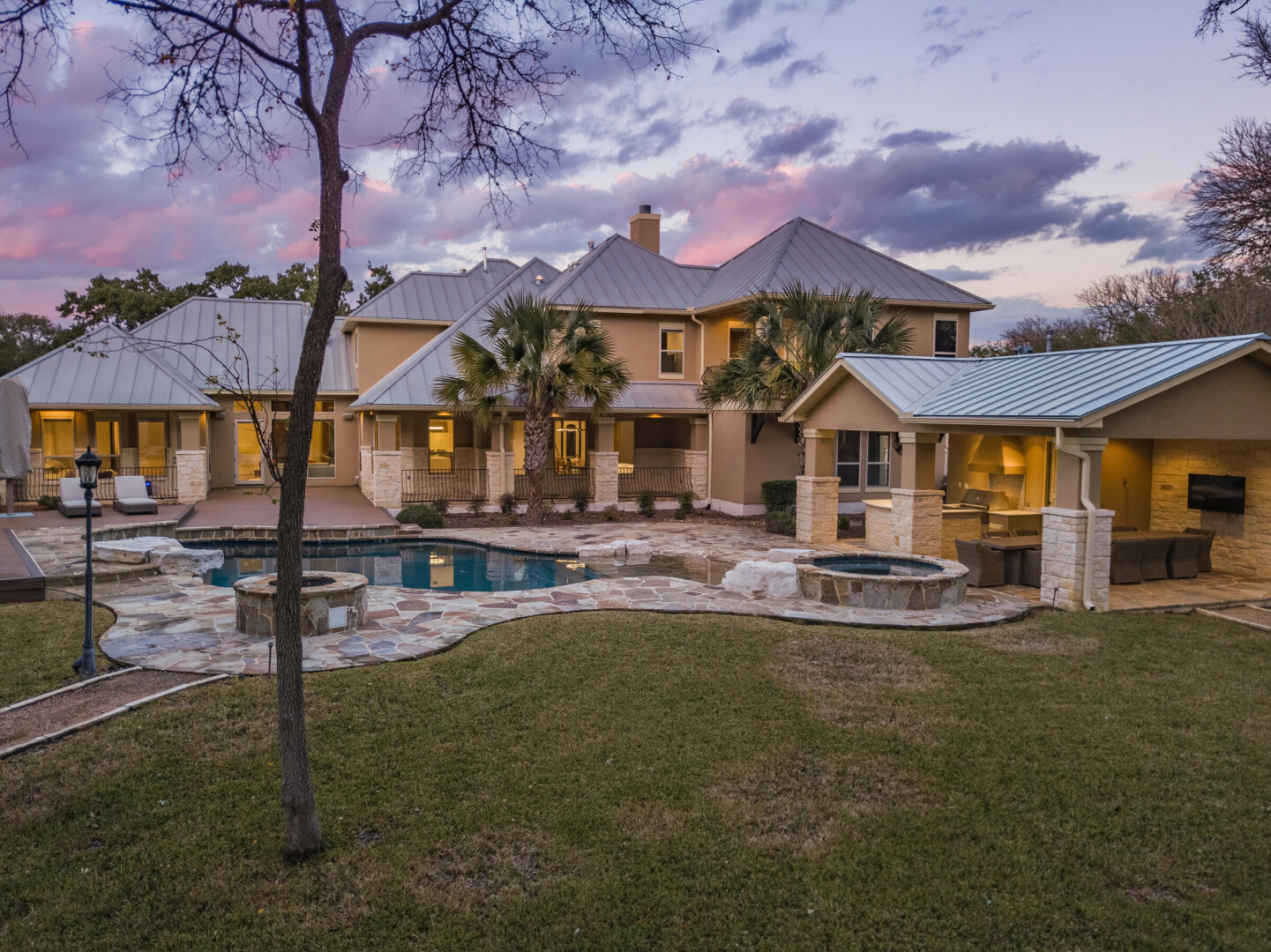 Rear view of a transitional custom home at sunset, San Antonio TX